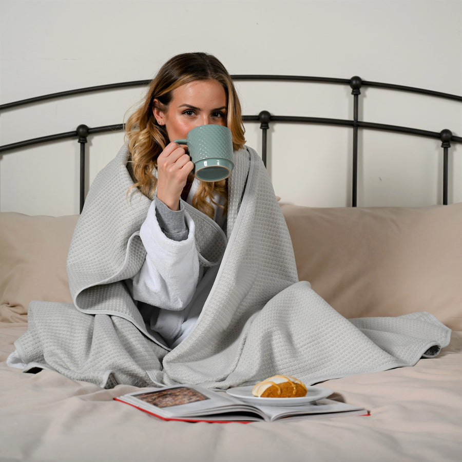 Woman wrapped up in a earl grey brushed cotton blanket