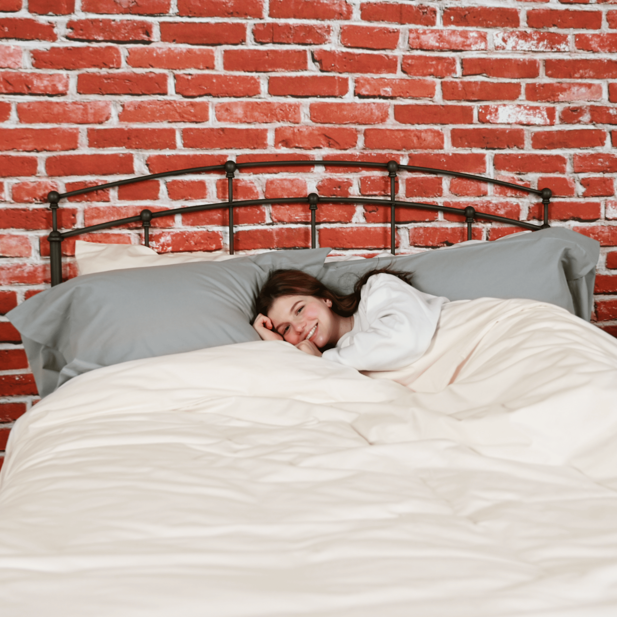 Woman laying in bed Featuring Chalk Organic Duvet Cover