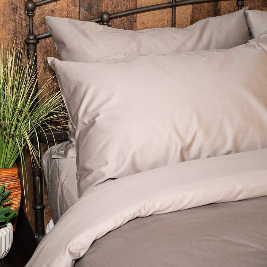 Bed featuring white refined sateen sheet set