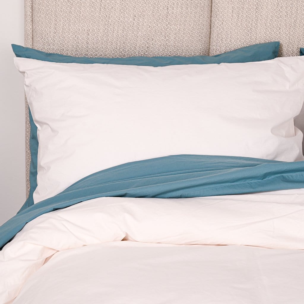 Bed featuring white washed percale pillowcase and baltic sea washed percale pillowcase