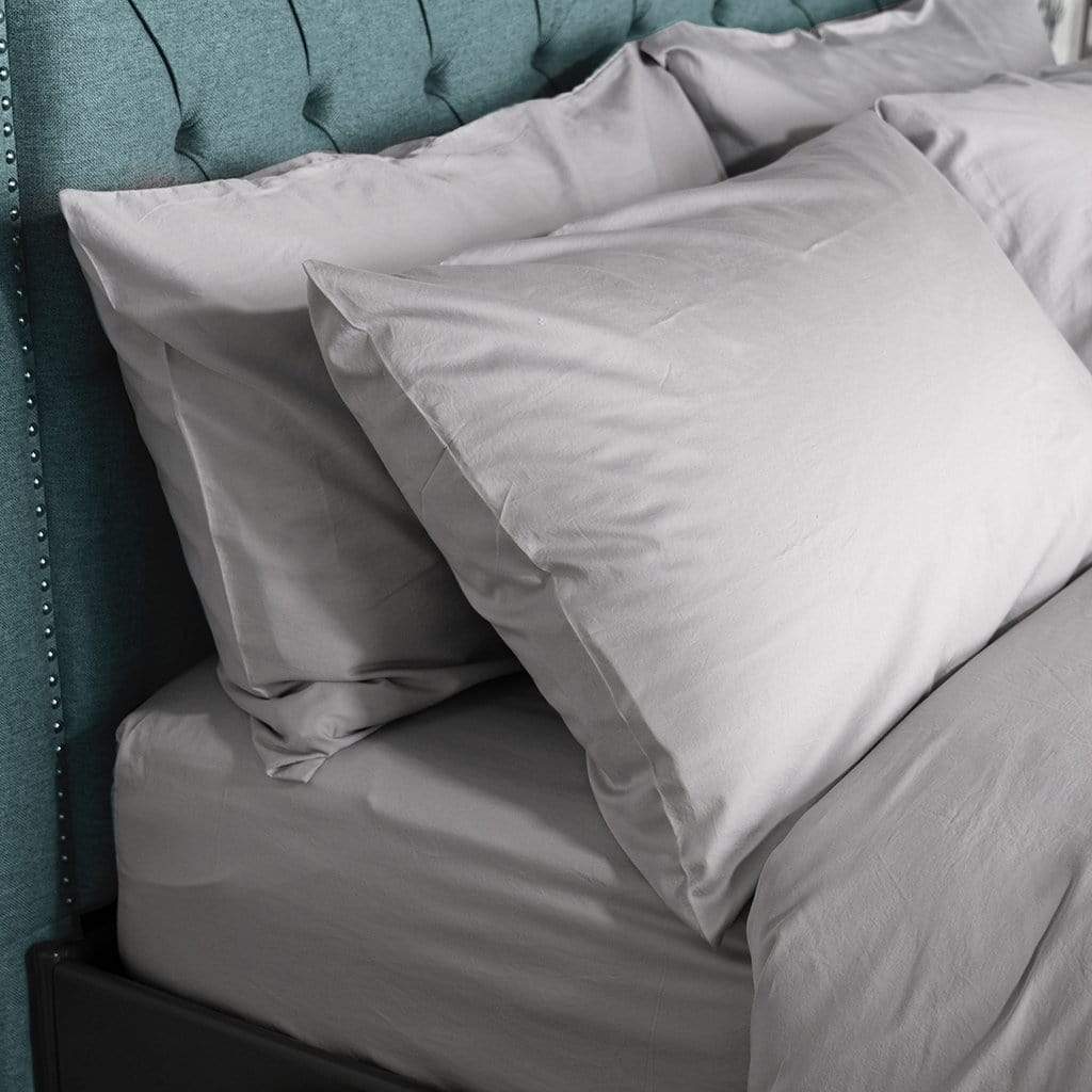 close up of bed featuring light grey washed sateen pillow cases
