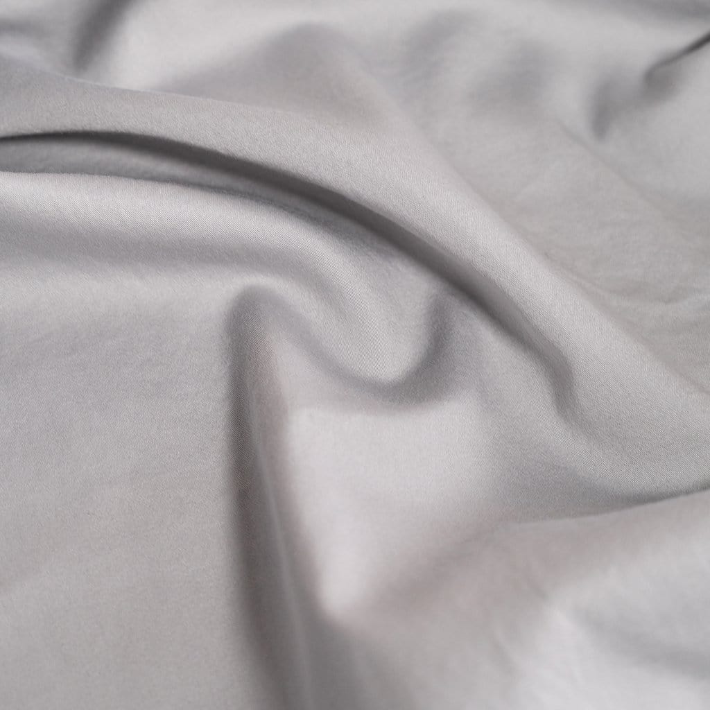 Close up of washed light grey sateen duvet cover
