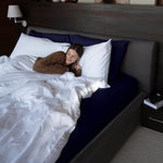 Woman laying in a Bed featuring Navy Organic Flannel Sheet Set