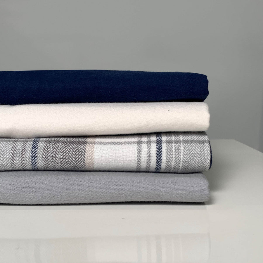 Stack of Folded Organic flannel Pillowcases in Navy Chalk Plaid and Pewter